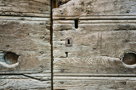 Old wooden door texture with a keyholeの写真素材