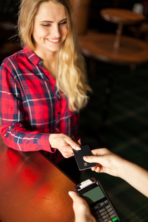 Attractive adult glad woman smiles when shopping in storeの写真素材