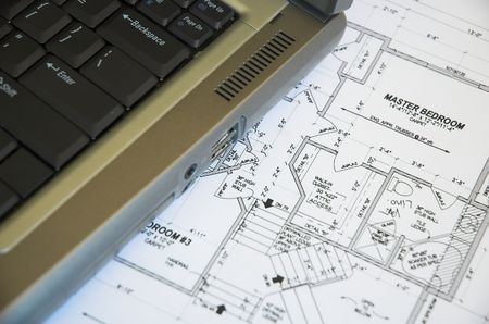 Laptop computer and residential blueprints.の写真素材