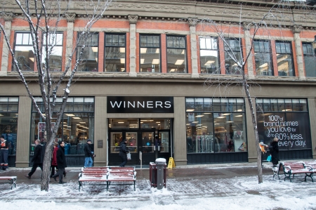 CALGARY, CANADA - DEC 12  Pedestrians walking past Winners on December 12, 2013 in Calgary, Alberta  Winners is one of Canada s largest discount retailers  Snow abounds のeditorial素材