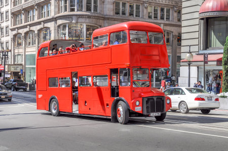 Double decker tourist bus in in San Francisco on August 17, 2009 in San Francisco. The brightly painted bus is scene here passing famous Union Square.のeditorial素材