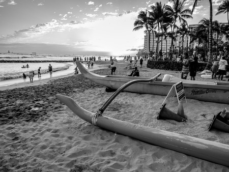 Tourists on the beach front at sunset on Waikiki beach April 27, 2014 in Oahu. Waikiki beach is beachfront neighborhood of Honolulu, best known for white sand and surfing.のeditorial素材