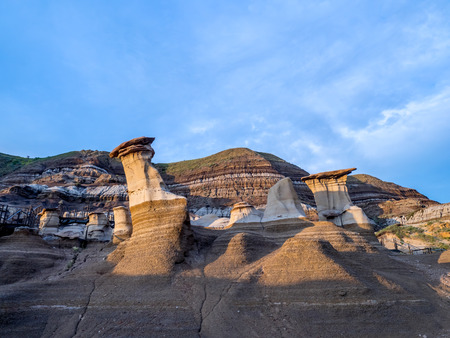 Hoodoos bathed in the warm light of a summer sunset at Drumheller Alberta Canada.の写真素材
