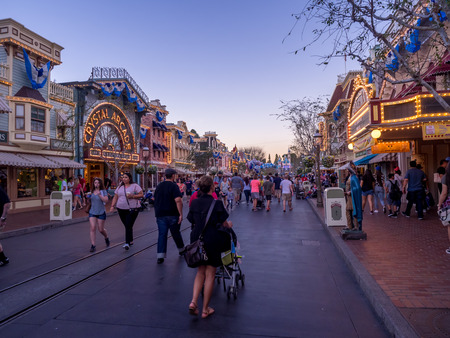 ANAHEIM, CALIFORNIA - FEBRUARY 15: Tourists enjoying Main Street Disneyland in the evening on February 15, 2016 in Anaheim, California. Disneyland is Walt Disney's original theme park.のeditorial素材