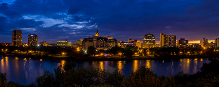 Saskatoon skyline at night along the Saskatchewan River.の写真素材