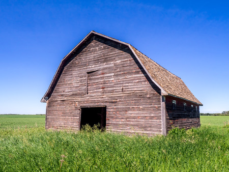 Old barn on the prairies in Saskatchewan on a summer day.の写真素材
