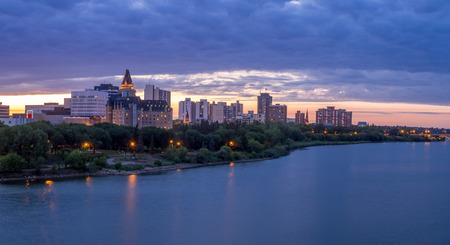 Saskatoon skyline at night along the Saskatchewan River.の写真素材