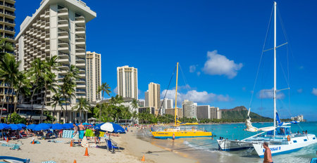 HONOLULU, HI - AUG 4: A catamaran waiting for tourists at Waikiki Beach on August 4, 2016 in Honolulu. Catamarans are a popular tourist activity at Waikiki Beach and offers a unique experience.のeditorial素材
