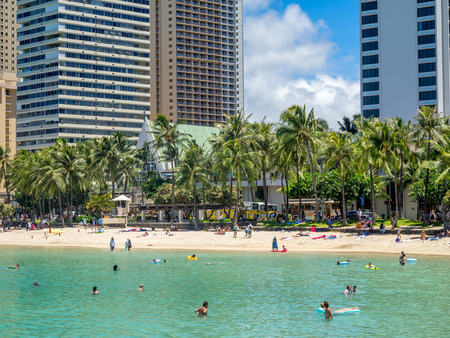 HONOLULU, USA - AUG 8: Sun lovers on Waikiki beach on August 8, 2016 in Honolulu, Usa. Waikiki beach is neighborhood of Honolulu, best known for white sand and surfing.のeditorial素材