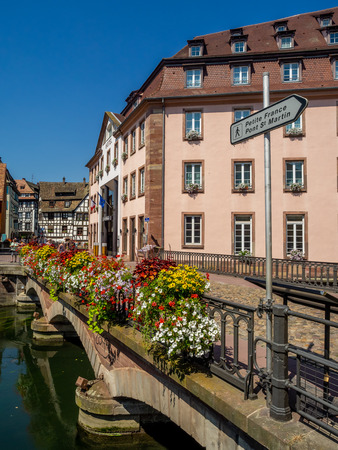 Along the Ill River in Petite France areas of Strasbourg in the Alsace region of France. The homes are the traditional half timbered houses visible all over this area of France.の写真素材