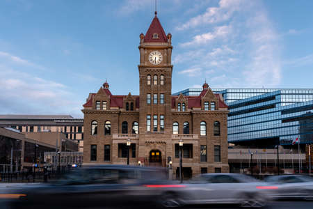 Calgary, Alberta - March 13, 2021: Cars cruising past Calgary's historic city hall in the evening.のeditorial素材