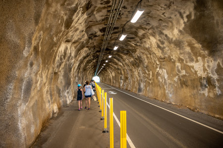 Honolulu, Hawaii - December 27, 2022: Tourists walking through the tunnel to the Diamond Head hike starting point.のeditorial素材