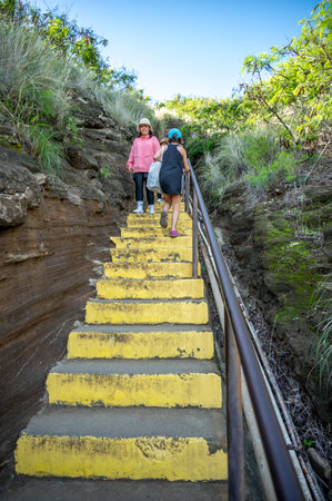 Honolulu, Hawaii - December 27, 2022:  Tourists hiking on the Diamond Head lookout trail.