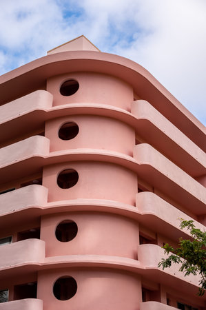 Honolulu, Hawaii - December 28, 2022: Exterior of a pink, retro art deco style apartment building in the heart of Waikiki.のeditorial素材