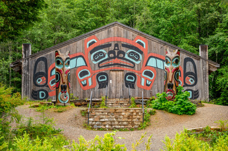 Saxman, Alaska - July 29, 2022: Tlinget totem poles, long house and traditional art.のeditorial素材