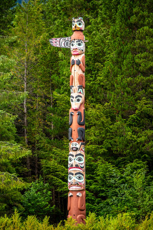 Saxman, Alaska - July 29, 2022: Tlinget totem poles, long house and traditional art.