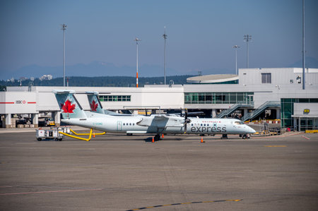 Vancouver, British Columbia - July 31, 2022: Air Canada regional aircraft on the tarmac of Vancouver's international airport.のeditorial素材
