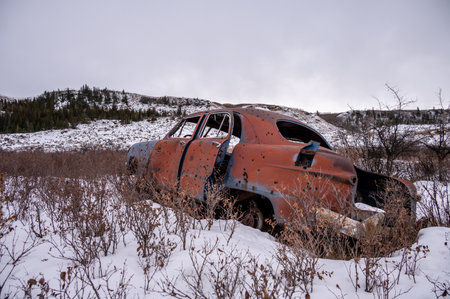Abandoned vehicles in a cold badlands environment.の写真素材