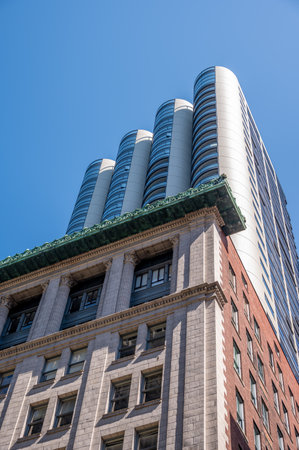 Vancouver, British Columbia - May 27, 2023: Looking up at a mix of heritage and modern skyscrapers.のeditorial素材