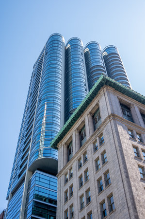 Vancouver, British Columbia - May 27, 2023: Looking up at a mix of heritage and modern skyscrapers.のeditorial素材