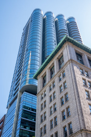 Vancouver, British Columbia - May 27, 2023: Looking up at a mix of heritage and modern skyscrapers.のeditorial素材
