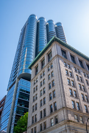 Vancouver, British Columbia - May 27, 2023: Looking up at a mix of heritage and modern skyscrapers.のeditorial素材
