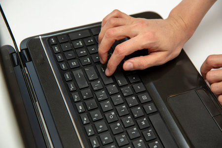 Work at home with laptop woman writing blog. Female hands on the keyboard, button enter