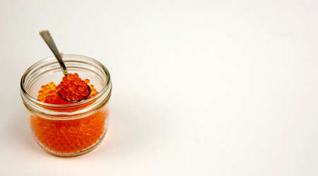 Red caviar spreading bread on a white backgroundの写真素材