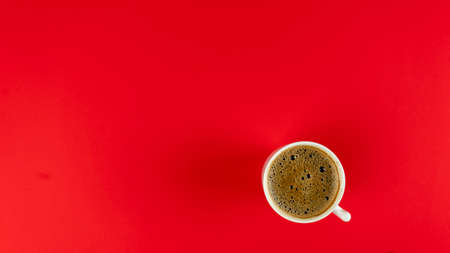 Glass of hot coffee on a red background. place for text. Mock upの写真素材