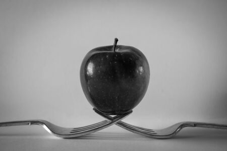 Red apple on two forks, Black and Whiteの写真素材