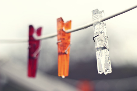Clothes pegs hanging outside in the summer rainの写真素材