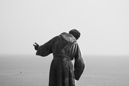 Catholic statues overlooking the ocean. St Francis statue in Cinque Terre, Italy.のeditorial素材