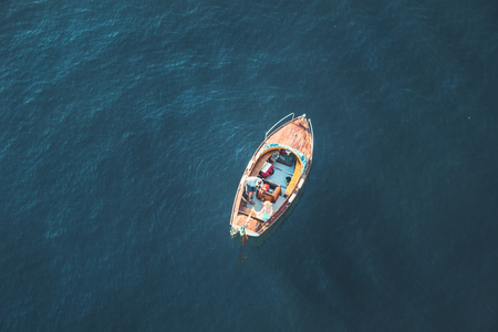 Beautiful summer seasonal photograph. Small boat in the archipelago with lots of colors and lights. Photo taken from above.の写真素材