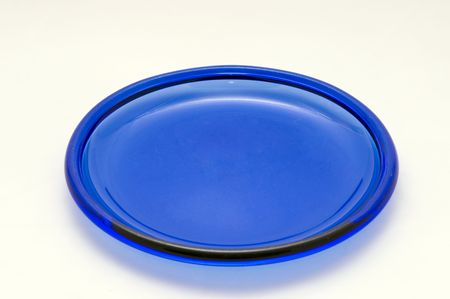 A blue glass plate on a white background.の写真素材