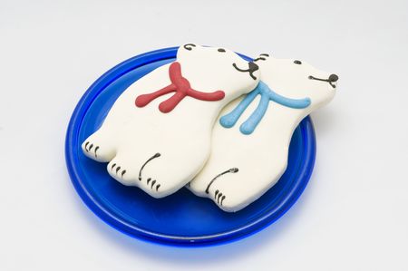 Two polar bear christmas cookies sit on a blue plate.の写真素材
