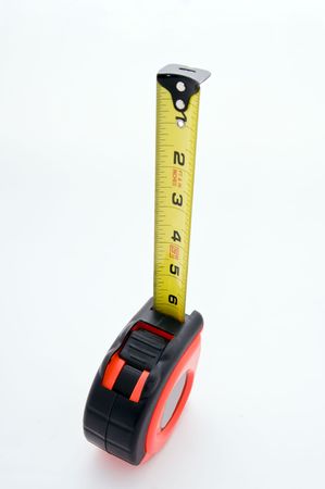 A tape measure on white extends upwards の写真素材