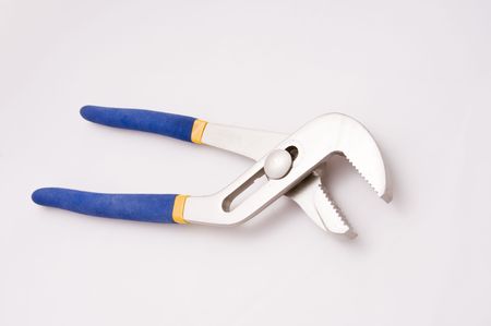 A slip joint wrench lays on white partially openの写真素材