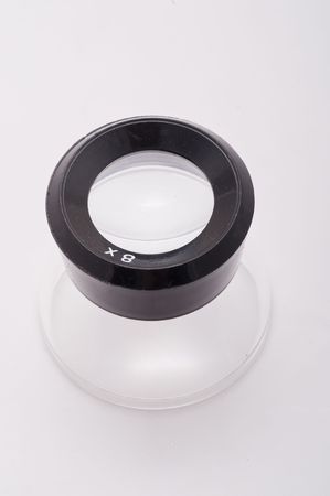 A top view of an 8x glass loupe on white with copy spaceの写真素材