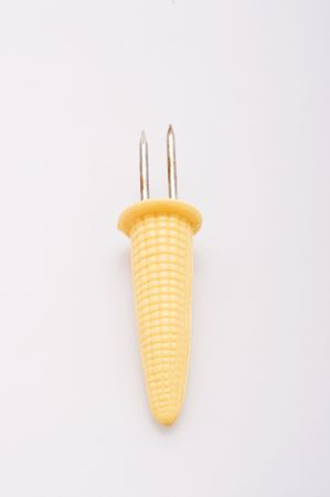 a kitschy yellow plastic corn cob holderの写真素材