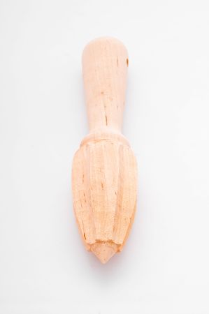 A wooden citrus fruit reamer sits on with with room for copy spaceの写真素材