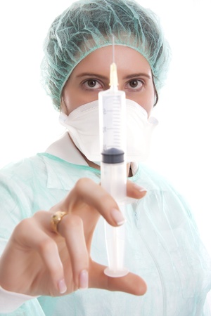 Nurse holding a syringe - isolated over whiteの写真素材