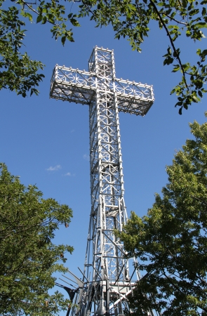 Large metal cross among trees in Montreal の写真素材