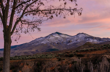 valley and peak of snow-capped mountain at sunset, hairy colors of the sunset.の写真素材
