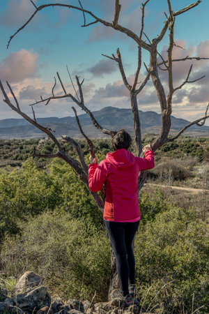 Happy woman enjoys the sunset views of the mountain, Spain.の写真素材