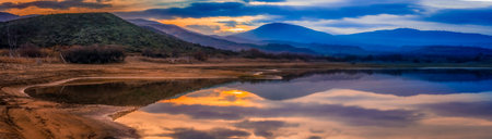 sunset on lake, reflection of clouds on waterの写真素材
