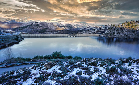sunset on the lake, reflections of mountains and cloudsの写真素材