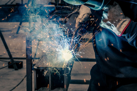 Welder, craftsman, assembly of iron, steel and other metals. Industrial steel welding technician in factory, construction professionals.の写真素材