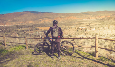 cyclist looking at the route before starting to pedalの写真素材