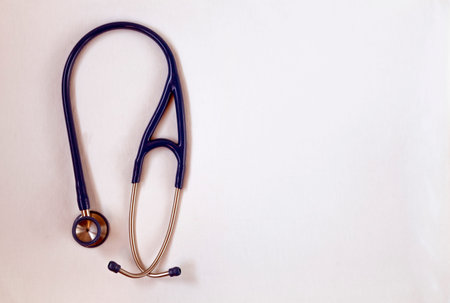 Specific medical equipment, blue stethoscope on a white background, used to listen to the heart and...