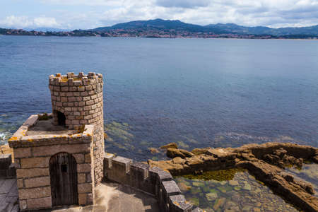 watchtower on a hillside overlooking the sea. Baiona, Spain.の写真素材